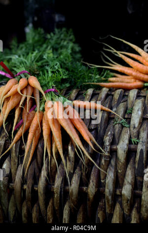 Fresh and organic Heritage carrots on a market stall with copy space ...