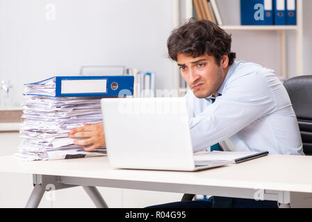 Overloaded busy employee with too much work and paperwork Stock Photo