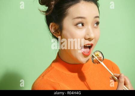 Young women eat sushi Stock Photo