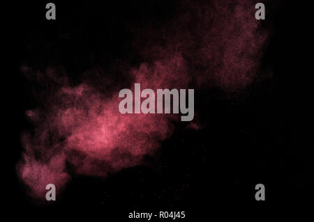 Abstract pink paint Holi. Abstract pink powder explosion on black background. Stock Photo