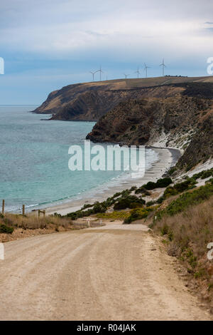 A portrait photo of Morgans Beach Cape Jervis showing the gravel access road and the starfish windfarm in the distance located in South Australia on 1 Stock Photo