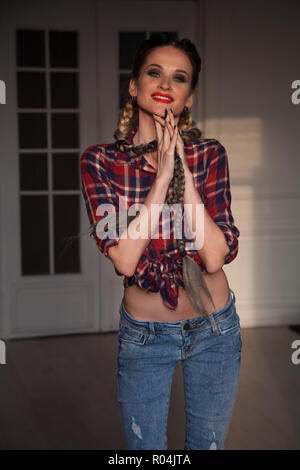 female mechanic in the garage with long braids with Stock Photo