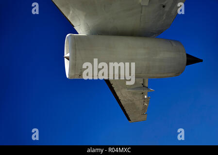 Airplane engine and wing detail against a deep blue sky. Aircraft in flight Stock Photo
