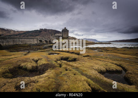 Eilean Donan castle on the shore of Lock Duich in cloudy day. Medieval castle in Scottish Highlands. Stock Photo