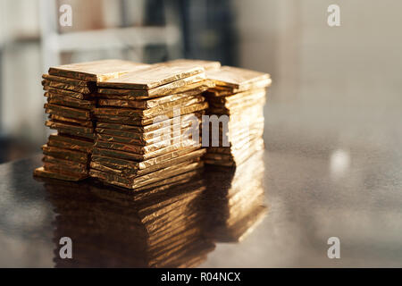 Stacks of freshly made chocolate bars in gold foil