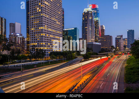 View of Downtown skyline and Harbour Freeway at dusk, Los Angeles, California, United States of America, North America