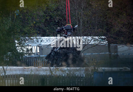 A crane moves part of the wreckage from the helicopter crash at Leicester City Football Club. Stock Photo