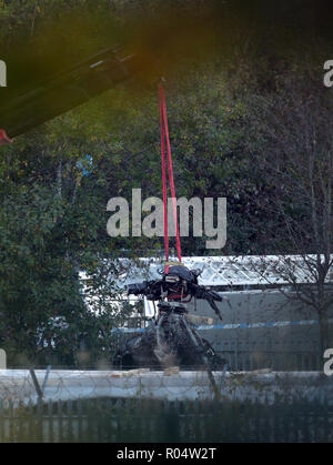 A crane moves part of the wreckage from the helicopter crash at Leicester City Football Club. Stock Photo