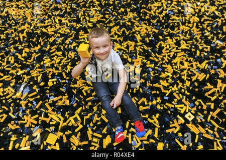 A little boy playing with lego bricks Stock Photo