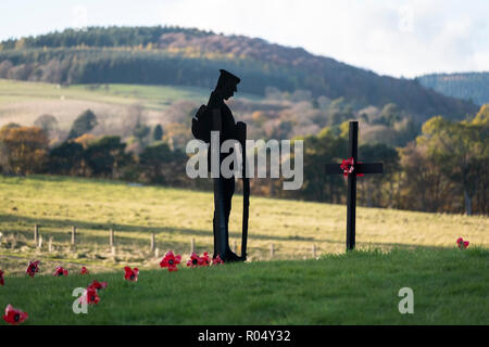 Galashiels, Scotland, UK. 1st Nov 2018.  Tweedbank Soldier Tribute A solitary figure of a WW1 soldier, with his head bowed stands in front of a black wooden cross, bearing a single poppy tribute, surrounded by small wooden crosses each with a poppy, in memory to the fallen. This display on Thursday 01 November 2018 at Tweedbank roundabout on the A6091, near to Galashiels in the Scottish Borders  (Photo by Rob Gray / Freelance) Credit: Rob Gray/Alamy Live News Stock Photo