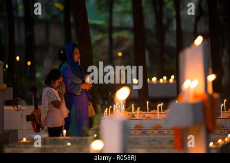 Dhaka, Bangladesh. 2nd Nov 2018.  Christian devotees observe All Souls' Day, known as the Feast of All Souls, Commemoration of all the Faithful Departed in Dhaka , Bangladesh on November 02, 2018.  On this day, Christians come to the graveyard and pray for the departed souls of their loved ones..All Soul's Day is a Roman Catholic day of remembrance for friends and loved ones who have passed away. Credit: zakir hossain chowdhury zakir/Alamy Live News Stock Photo