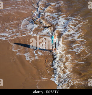 Sidmouth, Devon. 2nd Nov 2018. UK Weather: A woman paddles in the sea at Sidmouth on a sunny November afternoon. Photo Central/Alamy Live News Stock Photo