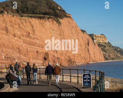Sidmouth, Devon. 2nd Nov 2018. UK Weather: People take a look at the famous red cliffs at Sidmouth on a glorious afternoon in November. Photo Central/Alamy Live News Stock Photo