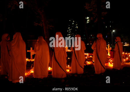 Dhaka, Bangladesh. 2nd Nov 2018. ‘All Souls Day’ is celebrated in the traditional Wari Christian graveyard in Dhaka, Bangladesh. European soldiers were tombed in this graveyard which is almost 300 years old. Recently convert Christian also tomb there. Many people are respect his relatives grave with candlelight. Credit: Mohammad Asad/Alamy Live News Stock Photo