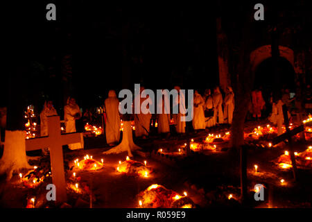 Dhaka, Bangladesh. 2nd Nov 2018. ‘All Souls Day’ is celebrated in the traditional Wari Christian graveyard in Dhaka, Bangladesh. European soldiers were tombed in this graveyard which is almost 300 years old. Recently convert Christian also tomb there. Many people are respect his relatives grave with candlelight. Credit: Mohammad Asad/Alamy Live News Stock Photo