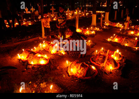 Dhaka, Bangladesh. 2nd Nov 2018. ‘All Souls Day’ is celebrated in the traditional Wari Christian graveyard in Dhaka, Bangladesh. European soldiers were tombed in this graveyard which is almost 300 years old. Recently convert Christian also tomb there. Many people are respect his relatives grave with candlelight. Credit: Mohammad Asad/Alamy Live News Stock Photo