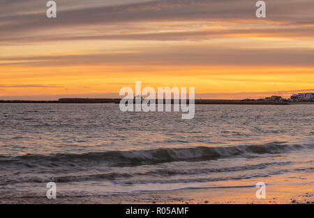 Lyme Regis, Dorset, UK. 2nd November 2018.  UK Weather:  Sunset at Lyme Regis at the end of a beautiful Autumn day.  The sky glows orange over the Cobb Harbour as the sun sets. Credit: Celia McMahon/Alamy Live News Stock Photo