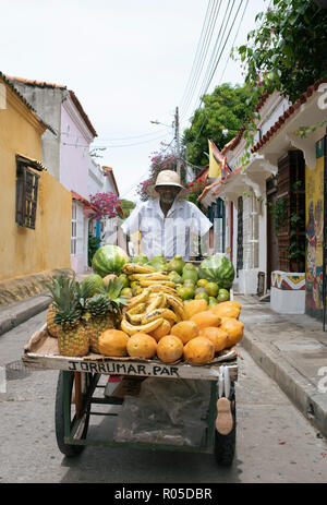 Portrait of local street fruit vendor pushing his cart on the streets of Getsemani, Cartagena de Indias, Colombia. Oct 2018 Stock Photo