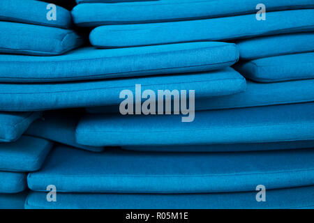 The mountain of blue pillows lie on one another. Pillow texture. Stock Photo