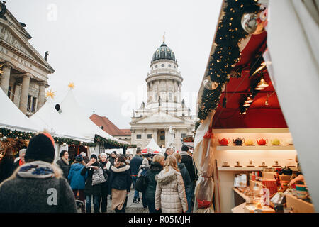 Berlin, December 25, 2017: People choose Christmas gifts at the traditional decorated Christmas market in Berlin, Germany. Stock Photo