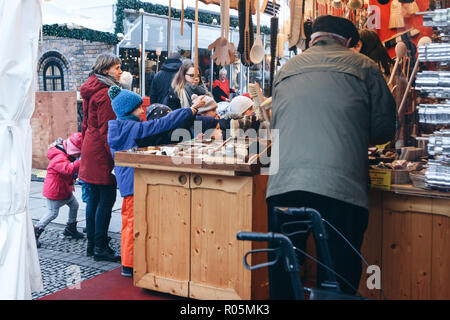 Berlin, December 25, 2017: People choose Christmas gifts at the traditional decorated Christmas market in Berlin, Germany. Stock Photo