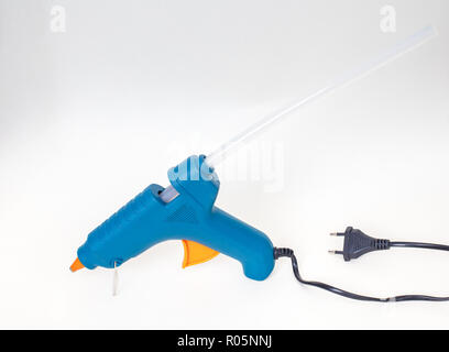 Blue glue gun isolated on white background with shadow Stock Photo