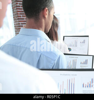 rear view.business colleagues holding folders with financial data Stock Photo