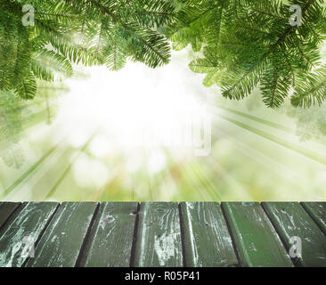 Christmas background. Pine tree branch, snow and empty wooden board on abstract soft focus background for product placement and advertising marketing Stock Photo