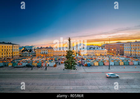 Helsinki, Finland. Christmas Xmas Market With Christmas Tree On Senate Square In Sunset Sunrise Evening Illuminations. Stock Photo