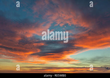 Dramatic colored sky. Moon and star in the clouds. Stock Photo