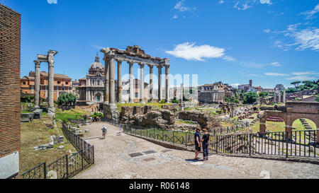 ruins of the Temple of Vespasian and Titus and the eight remaining columns of the Temple of Saturn above the Central Square area of the Roman Forum, t Stock Photo