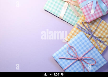 Check pattern colorful gift boxes on purple background Stock Photo