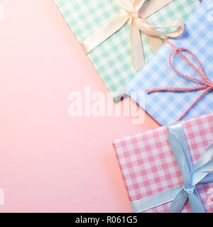 Check pattern colorful gift boxes on pink background Stock Photo