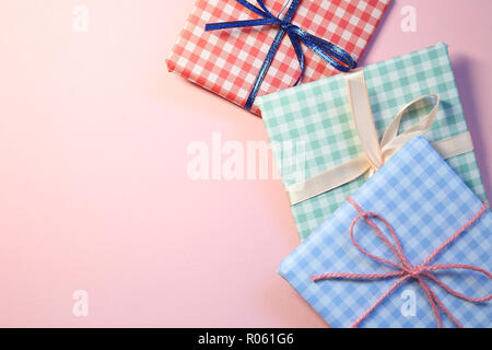 Check pattern colorful gift boxes on pink background Stock Photo