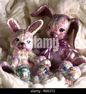 Colorful handmade Easter rabbits and decorated eggs. Stock Photo