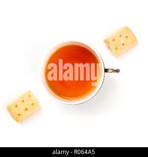A photo of two pieces of a Scottish shortbread butter cookie, shot from the top on a white background with a vintage cup of tea, with a place for text Stock Photo