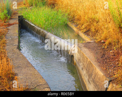 Road level irrigation canal in Andalusian countryside Stock Photo