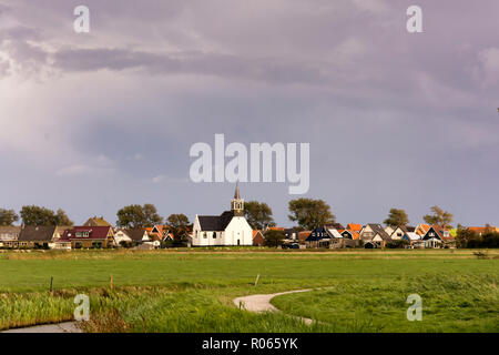 View on Oudeschild, a small historic town on the Wadden Island Texel, the Netherlands. The surroundings of the village with the white small church Stock Photo