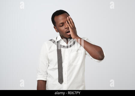 Handsome african guy having hangover after party. Stock Photo