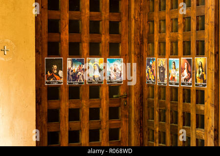 SAN BERNARDINO (RA), ITALY – OCTOBER 31, 2018: The priest put on the entrance of the church the images of the Saints to remind the religious connotati Stock Photo
