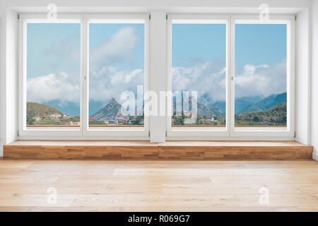looking through window in modern apartment with wooden floor and panorama view on mountain landscape Stock Photo