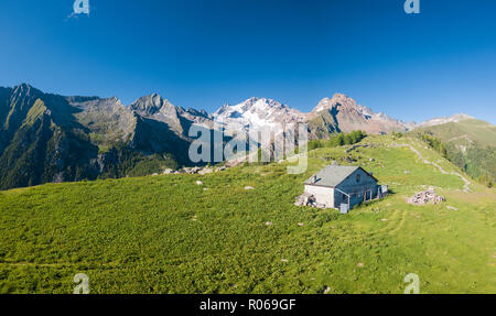 Panoramic aerial view of hut on green meadows, Scermendone Alp, Sondrio province, Valtellina, Rhaetian Alps, Lombardy, Italy, Europe