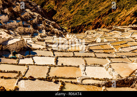 Salt terraces in the Sacred Valley where people are still mining and sifting the terraced pools as the Incas did 1000 years ago, Peru, South America Stock Photo