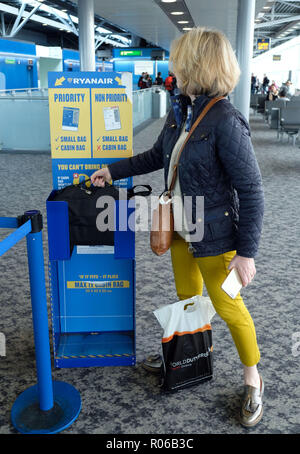 Pic shows: New tiny bag size allowed on Ryanair planes for free.  Checking sizer at all the gates to stop passengers see here at Stansted Airport.   P Stock Photo