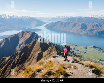 Woman hiker enjoying the view from the Roys Peak trail near Wanaka, Otago, South Island, New Zealand, Pacific Stock Photo