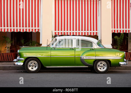 Green vintage American car parked in front of cafe, Cienfuegos, UNESCO World Heritage Site, Cuba, West Indies, Caribbean, Central America Stock Photo