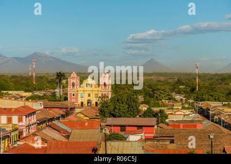 A view over the terracotta rooftops, of the colourful church of El Calvario, Leon, Nicaragua, Central America Stock Photo