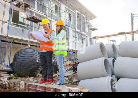 Two engineers working together at construction site Stock Photo