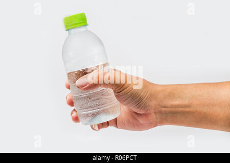 Drinking water bottle in hand on white background Stock Photo