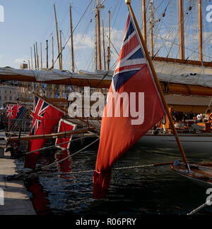 AJAXNETPHOTO. CANNES, FRANCE. - MERCHANT SHIP FLAG - RED ENSIGN OF THE BRITISH MERCHANT NAVY, THE MALTESE FLAG AND BRITISH BLUE ENSIGN FLYING FROM VARIOUS CLASSIC YACHTS MOORED IN THE OLD PORT.  PHOTO:JONATHAN EASTLNAD/AJAX REF: GX8 182509 589 Stock Photo